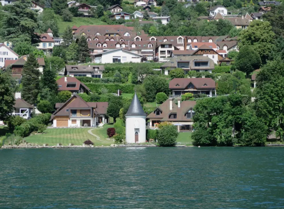 Waterfront building with pointed roof. 