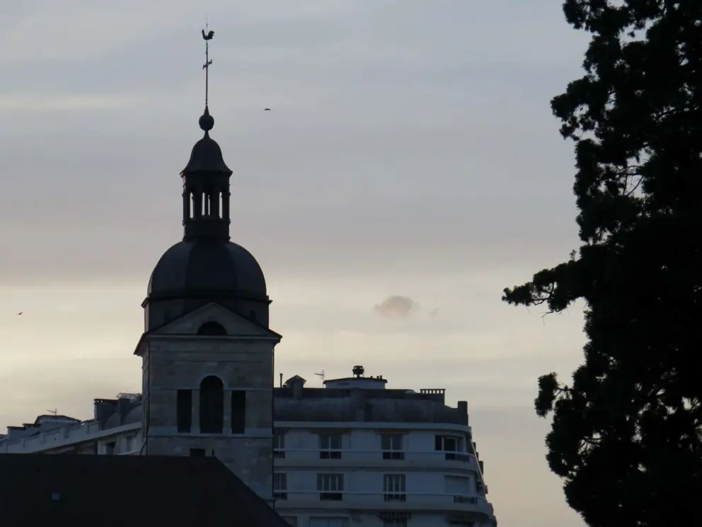 Eglise Saint Maurice d'Annecy, with its metal tower silhouetted against the night sky. 