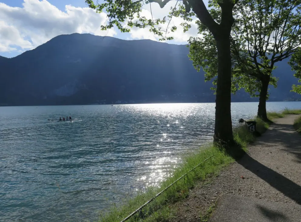 Paddlers on the glistening lake, and the walking path that hugs the shore. 