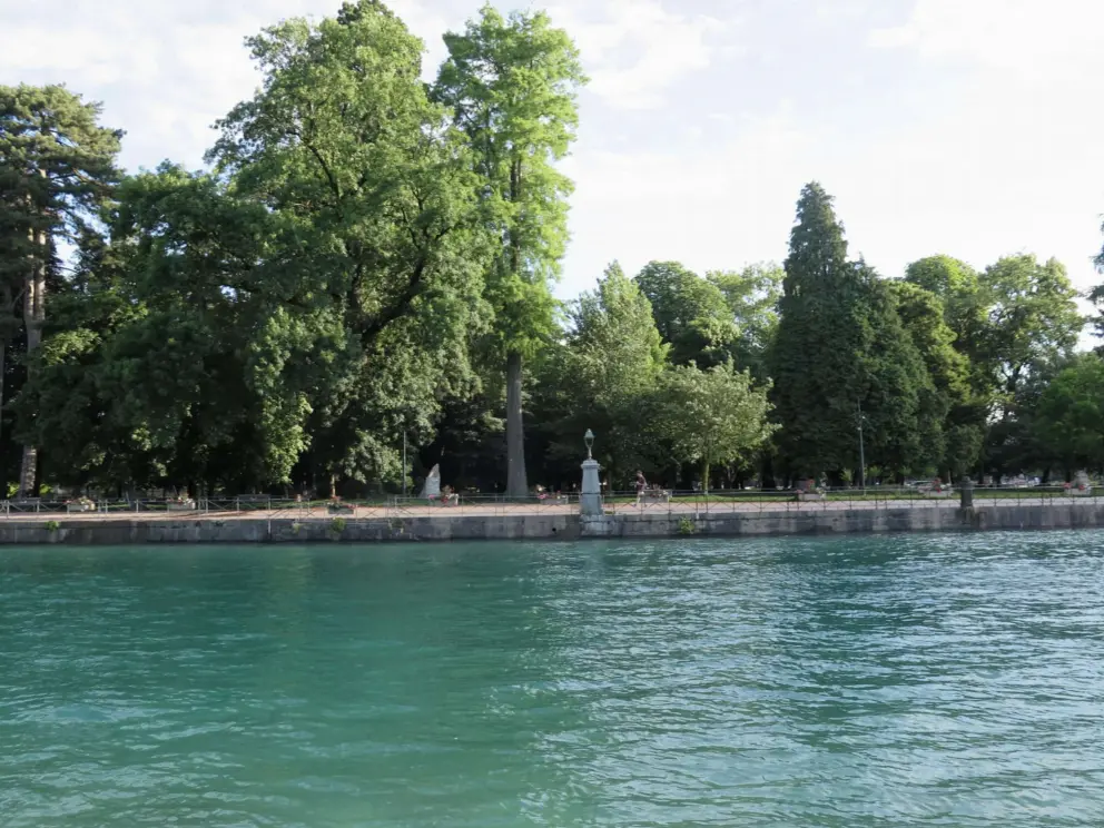 The luminous green water at Quai de la Tournette, with Jardins de l'Europe across the water. 