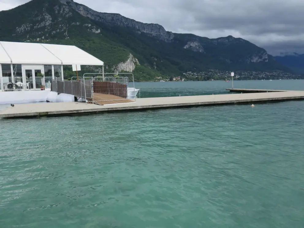 The color of the water and the mountain views from the dock at Plage de l'Imperial. 