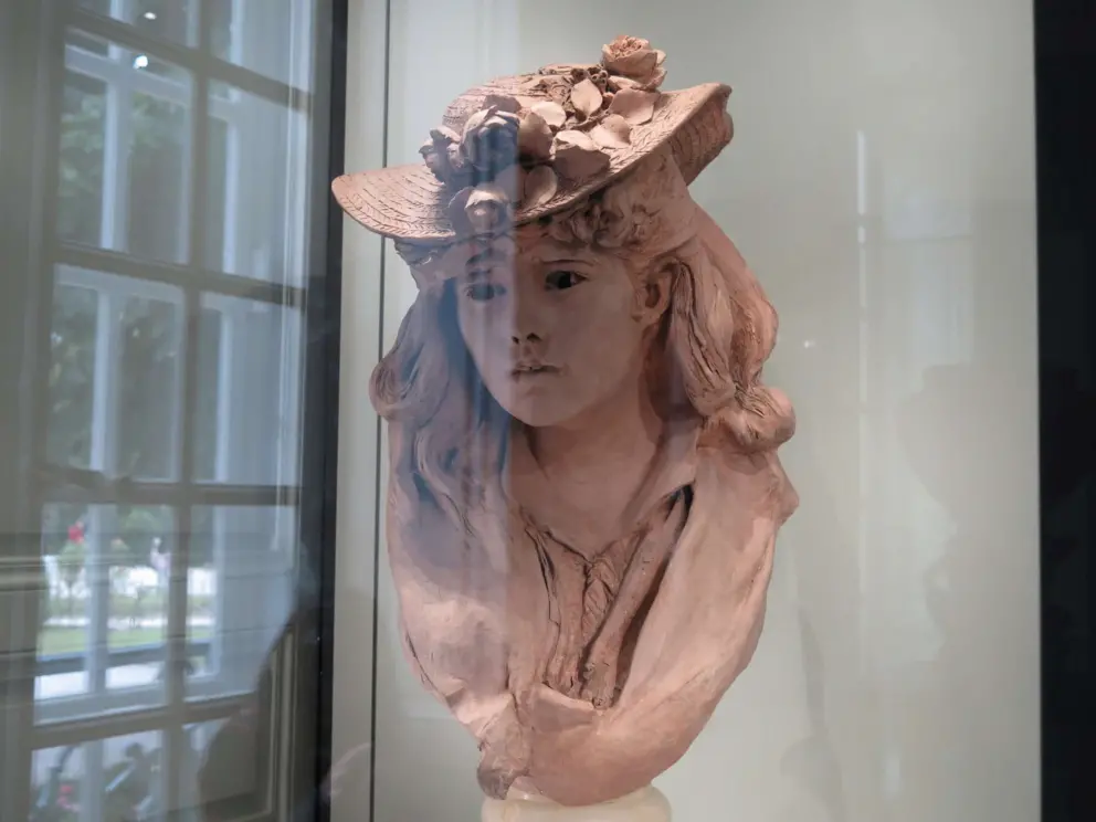 Young Girl with Flowers on her Hat. 