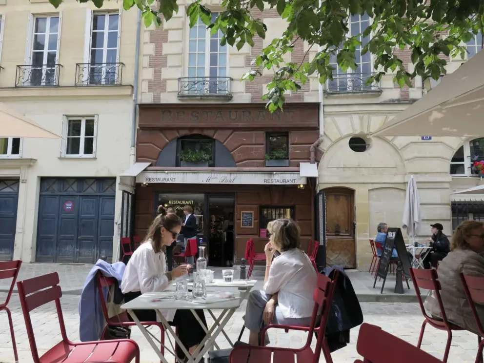 Two ladies enjoy a break at Restaurant Paul in Place Dauphine. 