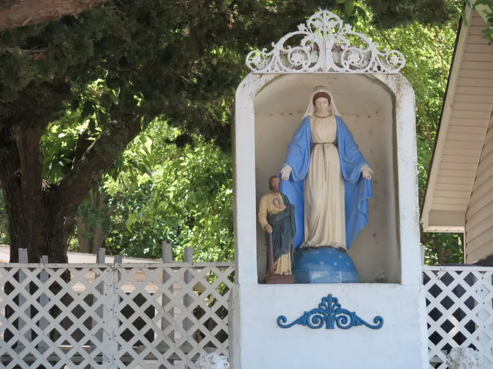 Outside Santa Margarita de Cortona Catholic Church is a statue of Mary. 