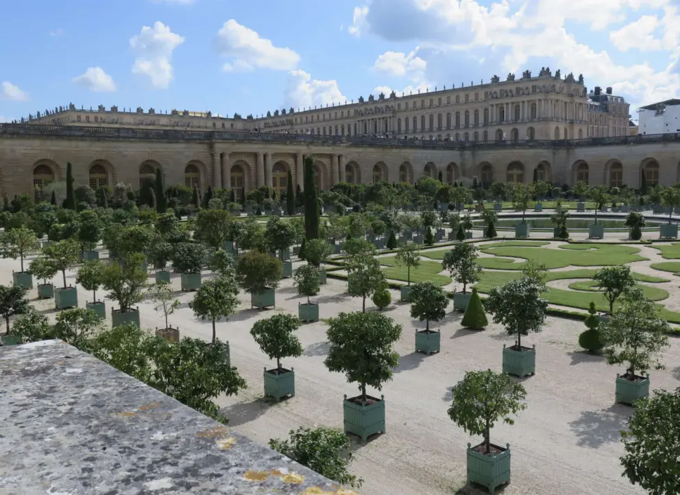 Rows of orange trees and geometric design of the Orangerie, with the palace behind.
