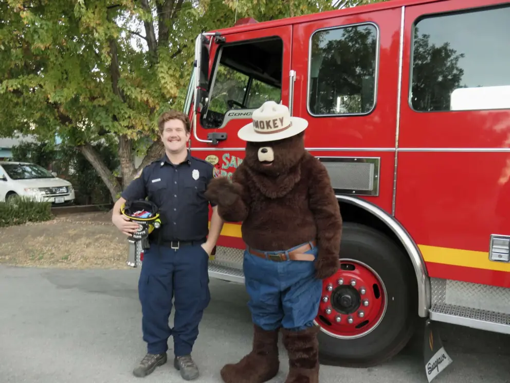Smokey the Bear next to a firefighter on I Street on Halloween!