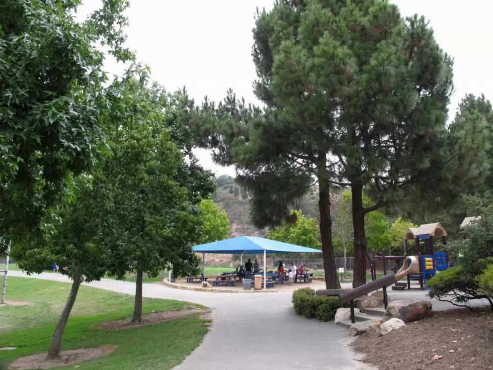 Cappello Playground, a lovely setting with the trees and the hill behind.