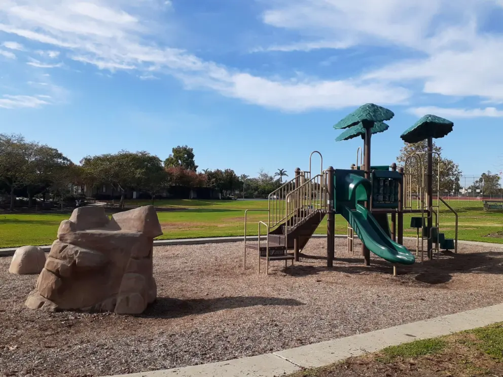 The playground and rock climbing boulder. 