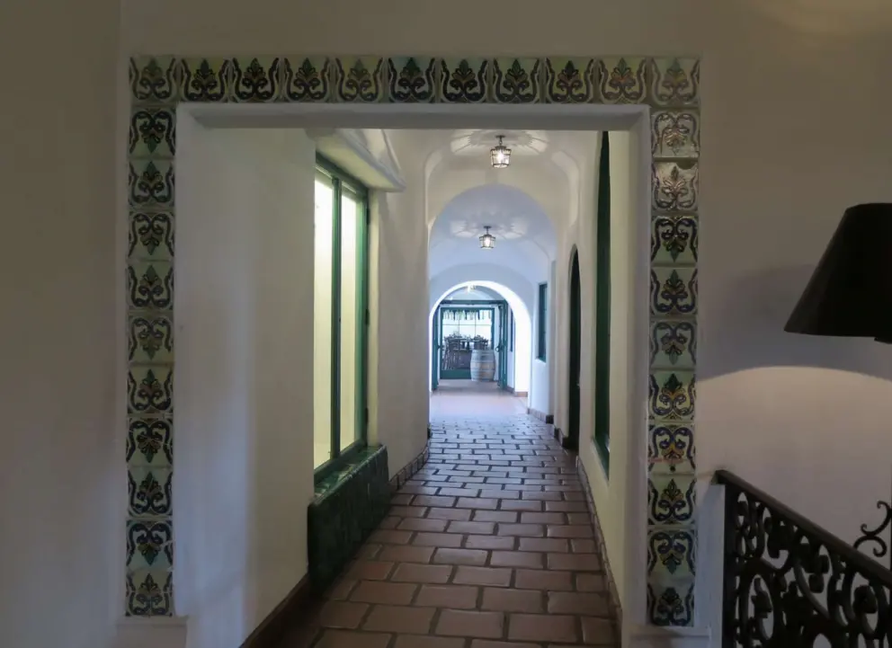 Gorgeous hallway with tilework and Mexican floor tile, leading to El Paseo Restaurant. 