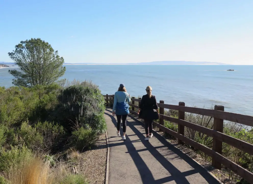 Two women walk the trail. 
