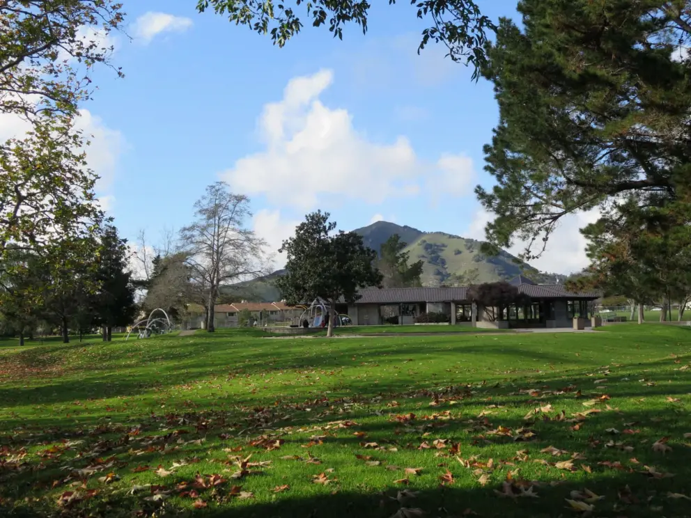 Huge lawn with playground and Madonna Mountain in the distance. 