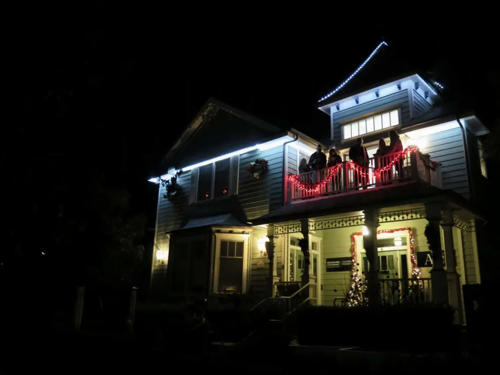 Beautiful home on Vine Street, with cheerful people on the balcony.