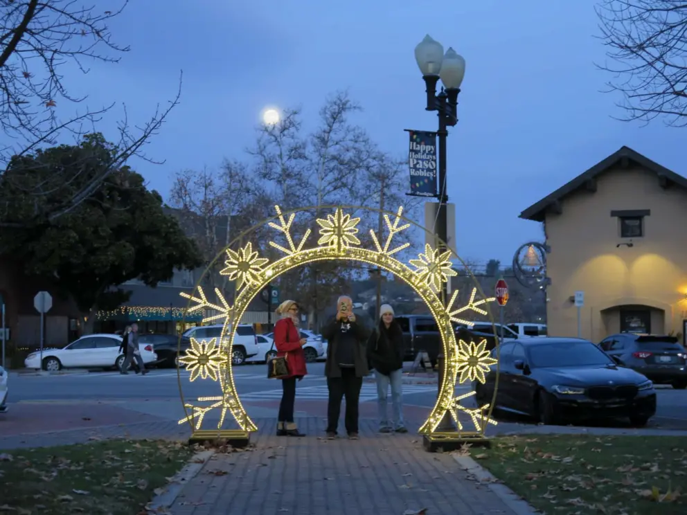 The full moon behind the snowflake arch. 