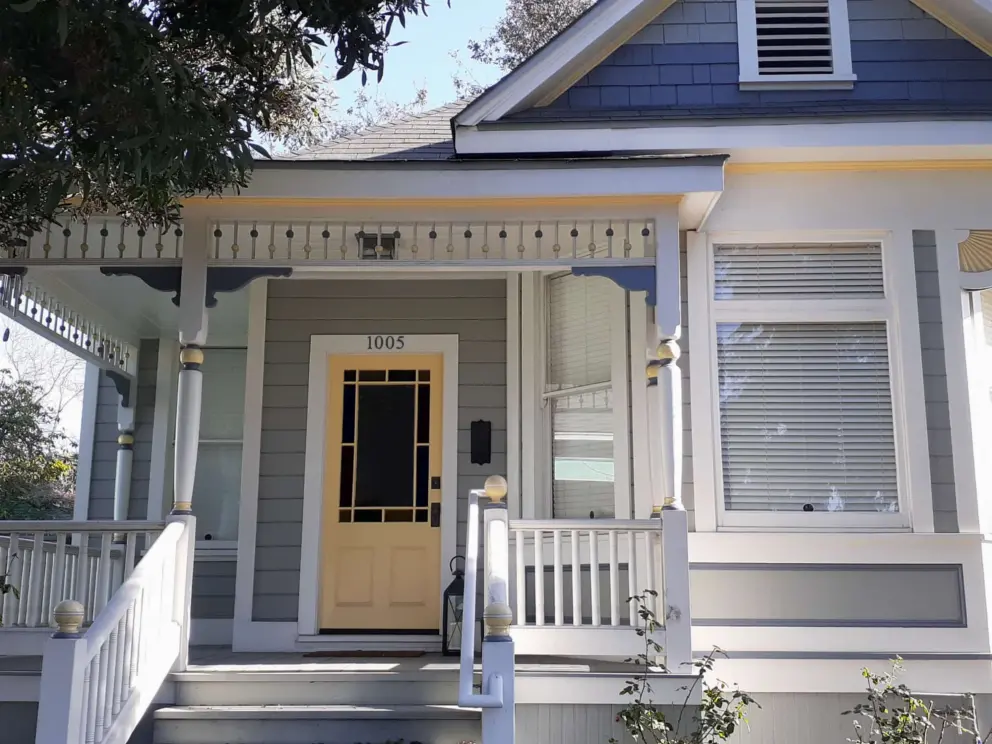 Yellow door and cute wooden beads at the top of the balcony. 