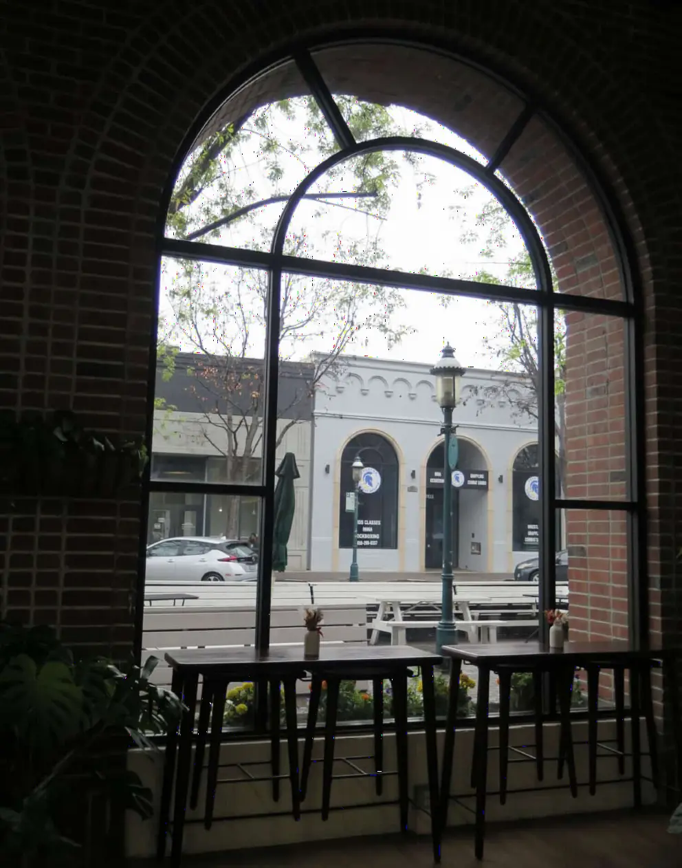 Arched window at Baires Bakery and Cafe, with pretty building outside. 