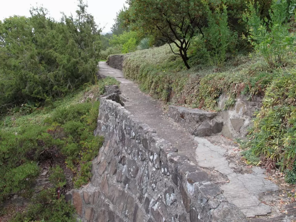 Stone wall supporting the path.