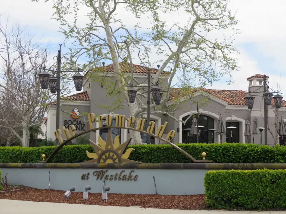 Entrance to the shopping center, with lanterns, Spanish tile, and pretty trees. 