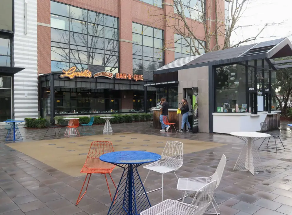 Seating outside the BBQ place, in a big public space. 