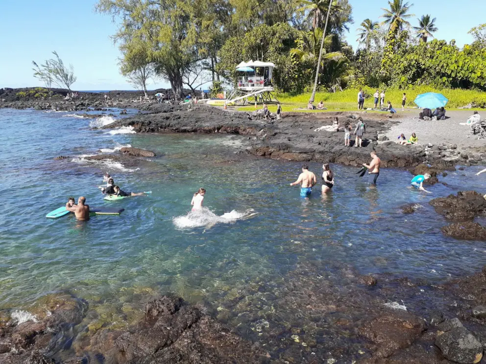 Swimmers entering the water, which is quite difficult. 