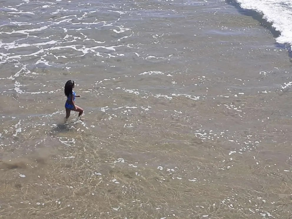 Walking into the clear water on an unusually clean day. 