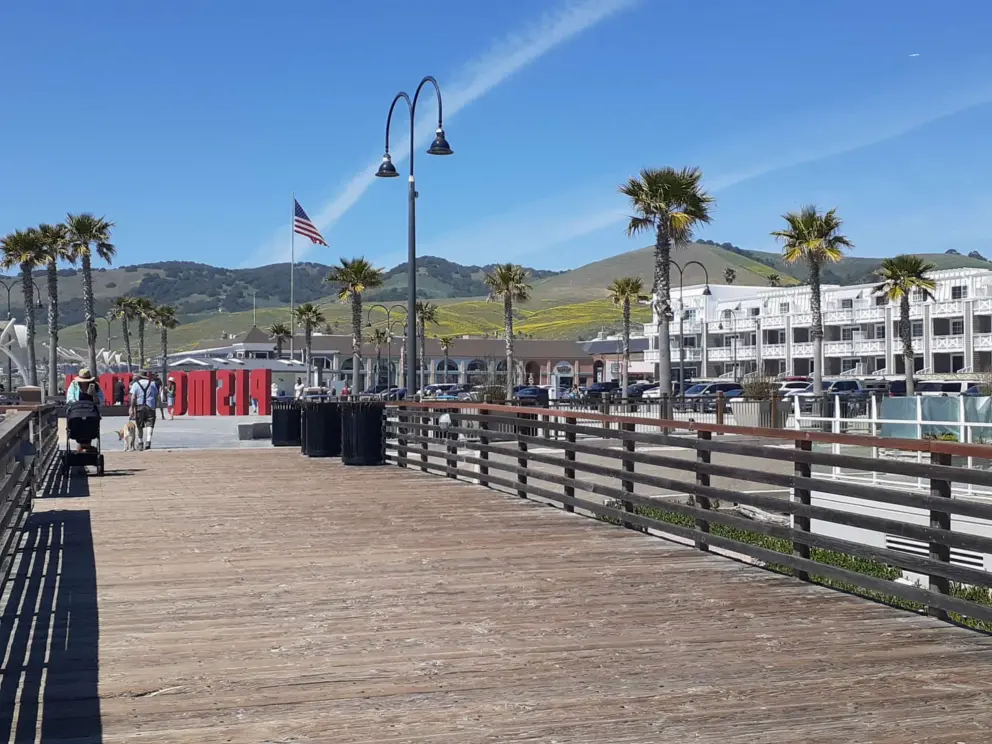 Boardwalk leading to the red Pismo Beach sign. 