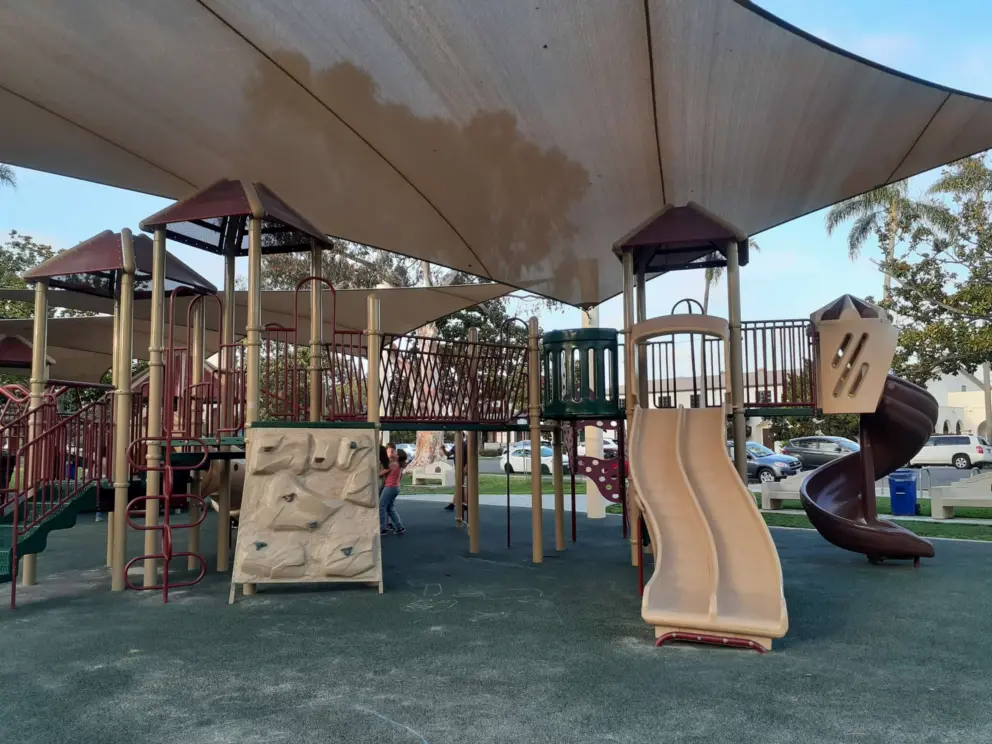The playground has a twisty slide and double slide. 