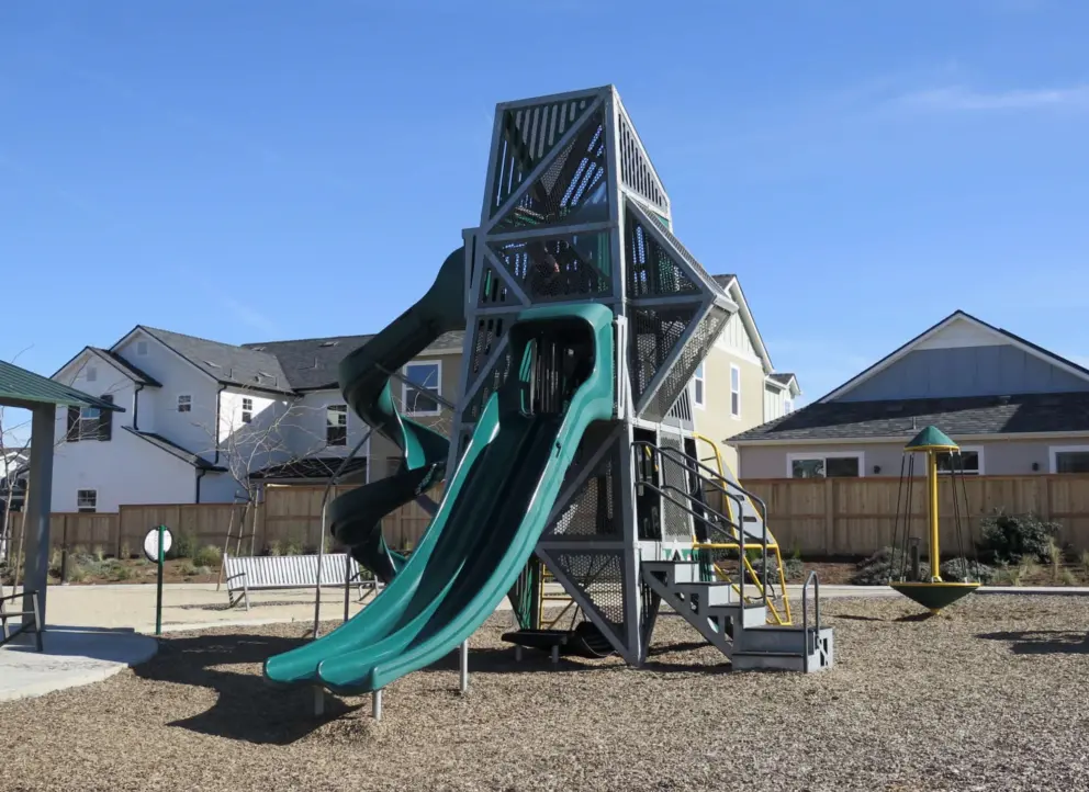 The three-storey climbing structure with double slide and twisty slide. 