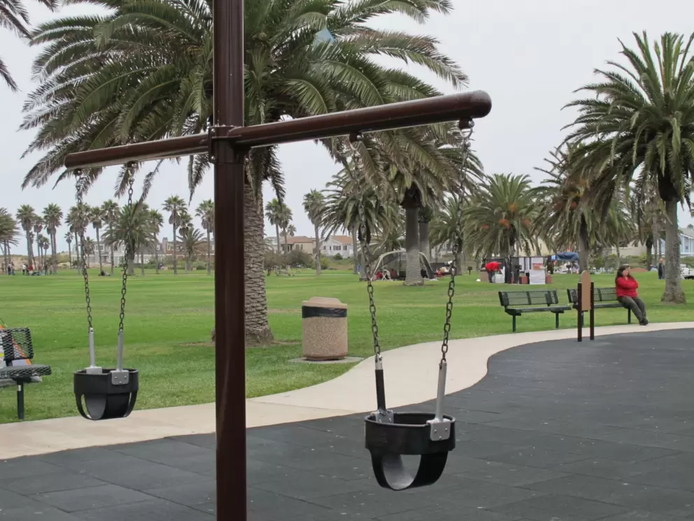 Baby swings and benches for parents.