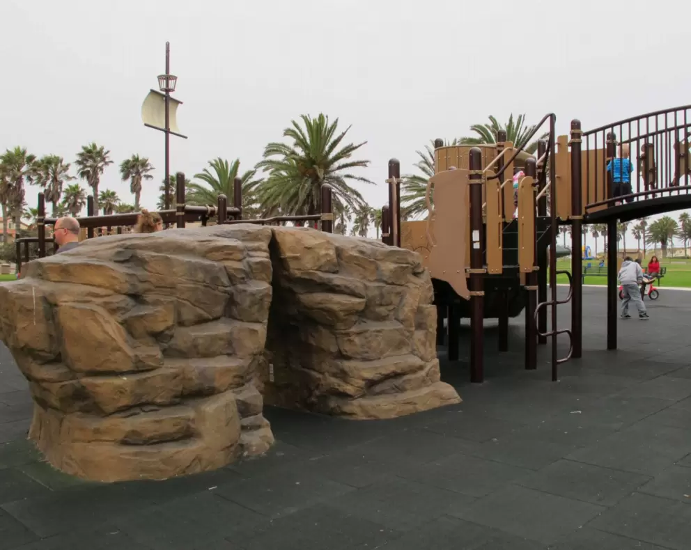 Rock climber and playground bridge with pirates on it.