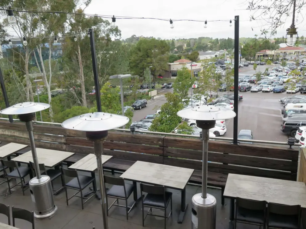 Seating at the bar at the very top of the sky deck, with views of eucalyptus trees. 