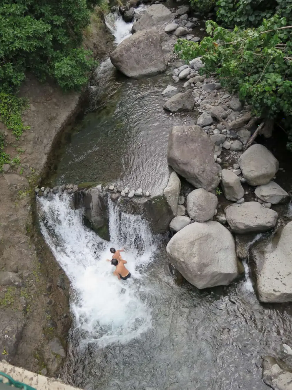 Boys playing in the river. Swimming is not recommended, however. 