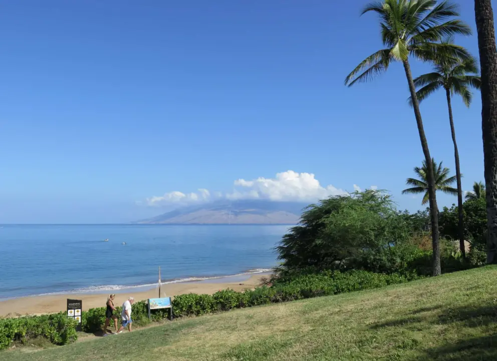 View of Wailea Beach and the windmills of West Maui, from the grassy mound near the public parking lot. 