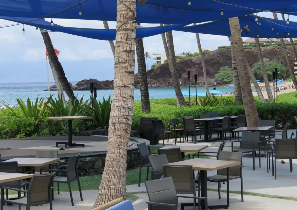 Seating outside Maui Brewing Company, with Black Rock in the distance. 