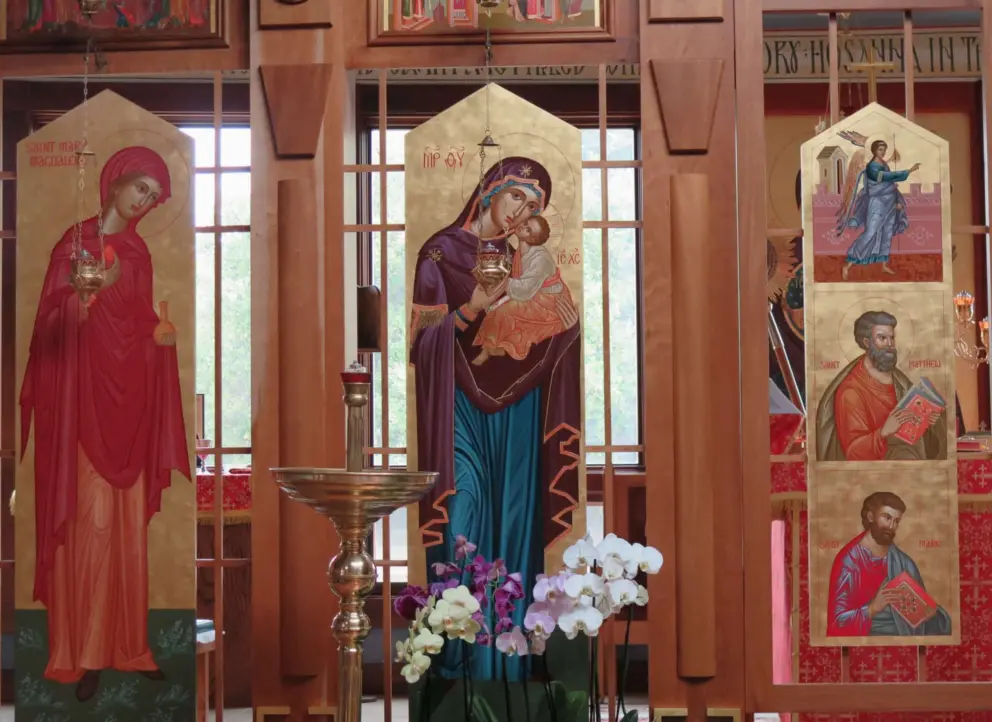 Saint Mary Magdalene, Mary and Jesus, and Saint Matthew at the front of the church. 