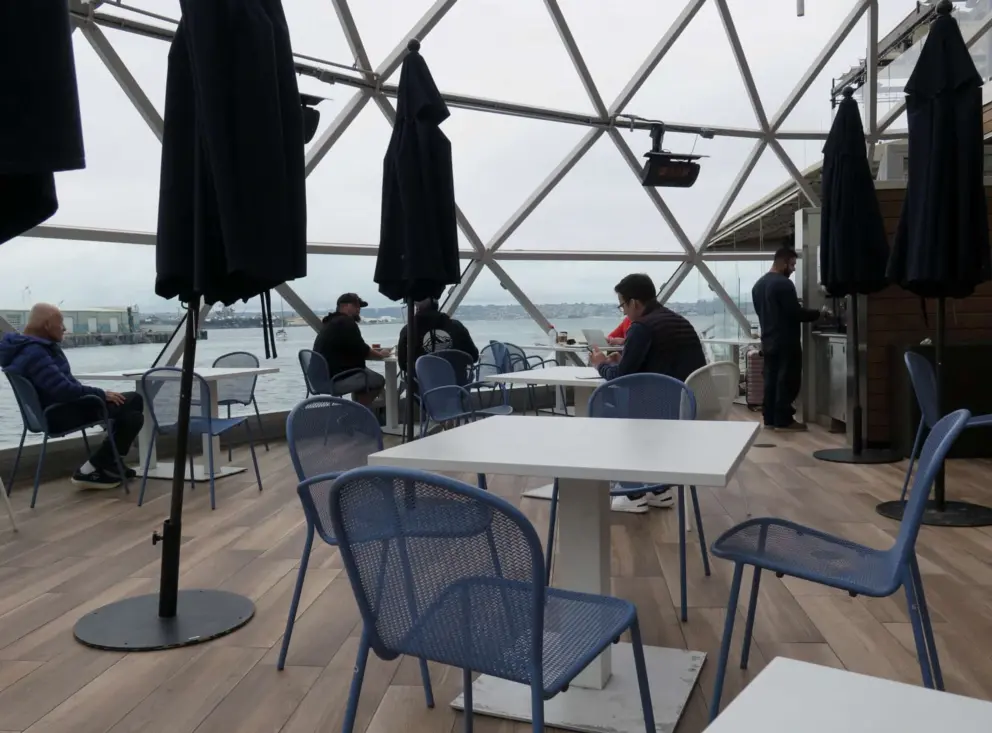 People sitting outside at Portside Pier. 