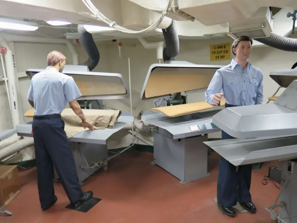 The laundry room and men at the presses. 