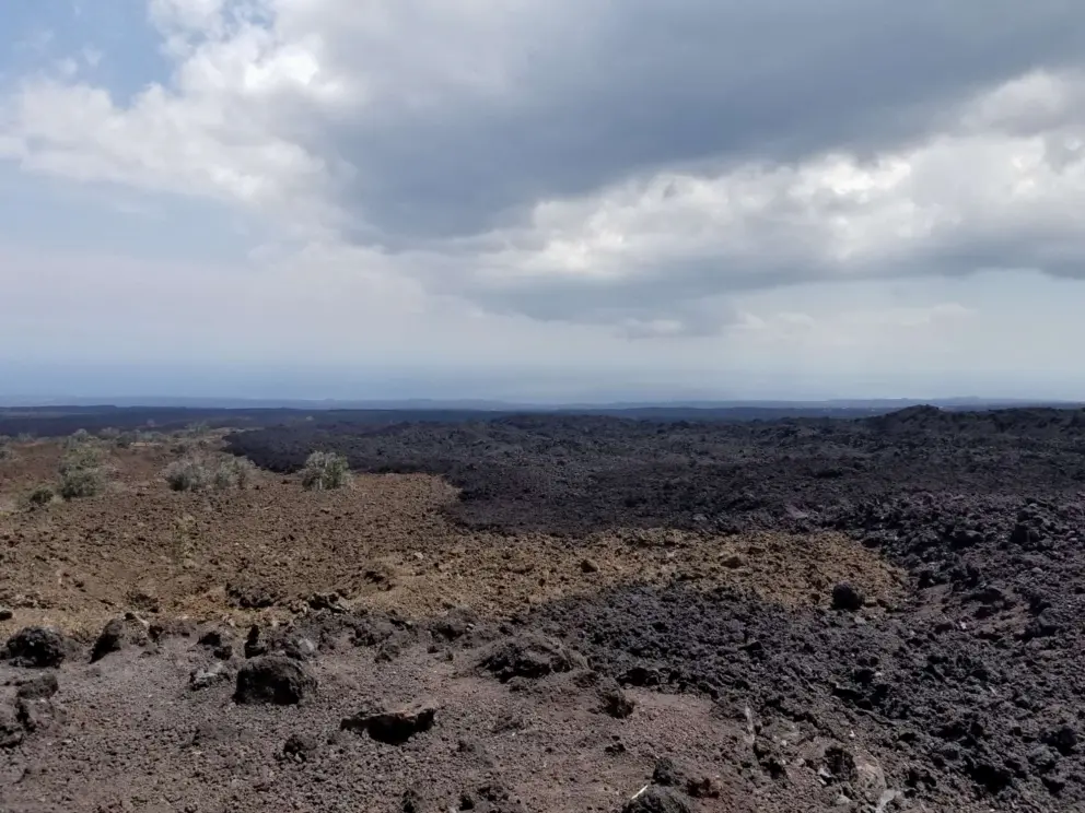 You can see the different lava flows that have happened at a lookout along Highway 11 near the volcano. 