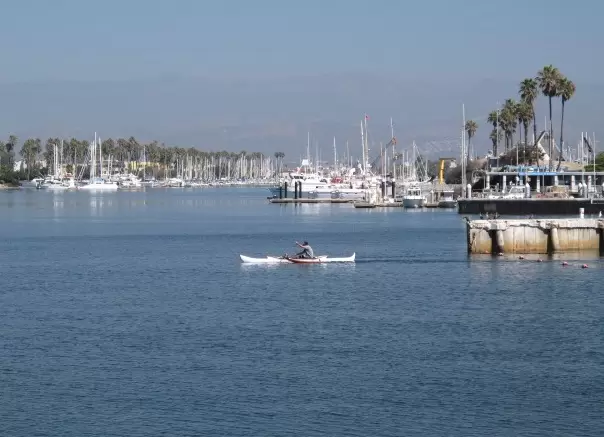 A kayaker heads out to the ocean.