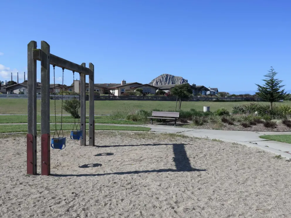 Baby swings and a bench nearby.