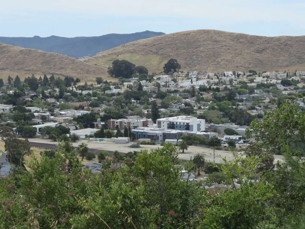 View of The Yard condos along the train track, with South Hills or Vulture Peak in the distance. 