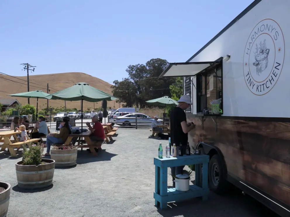The food truck and picnic tables. 