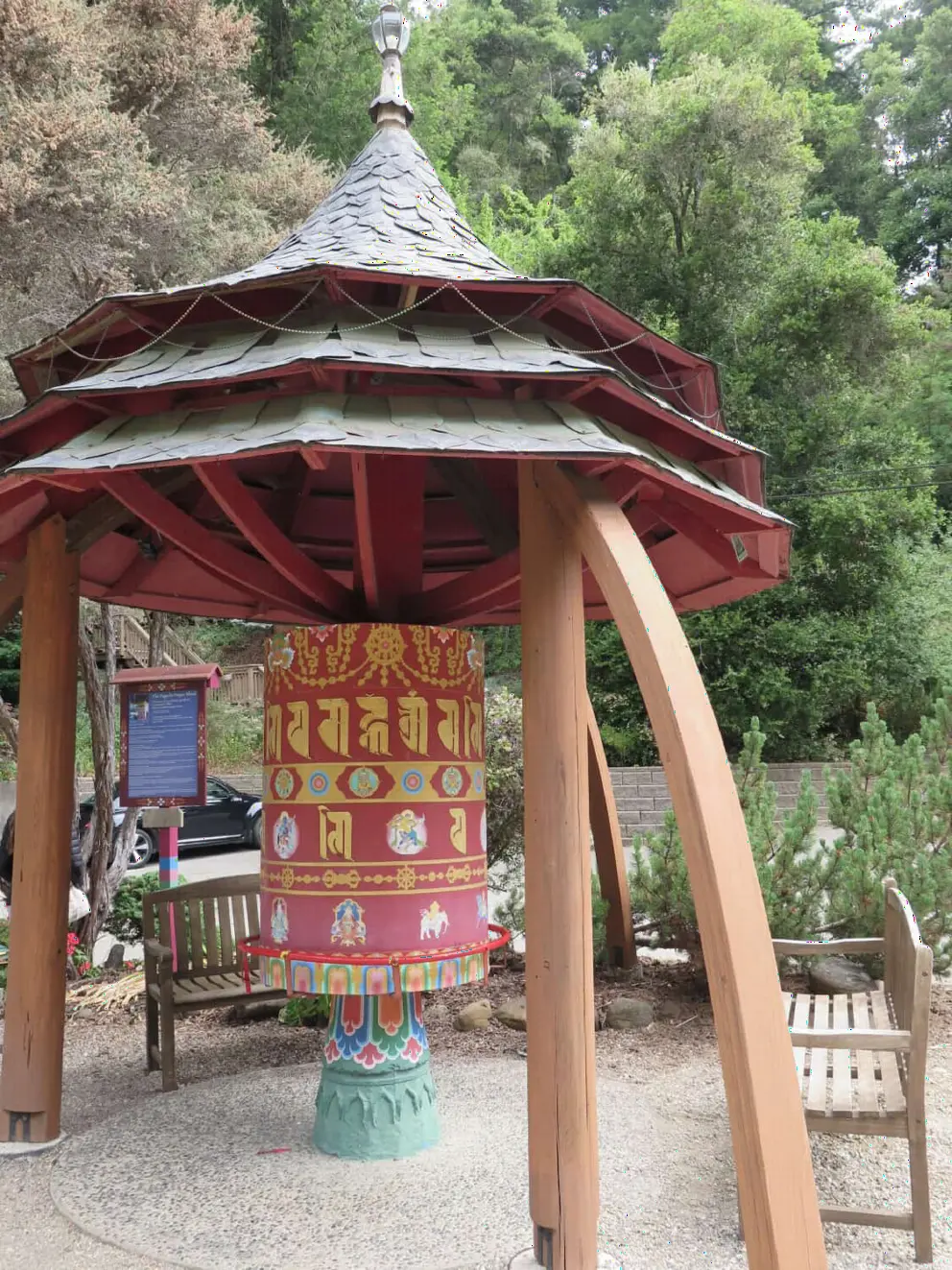 A prayer wheel with a pointy roof. 