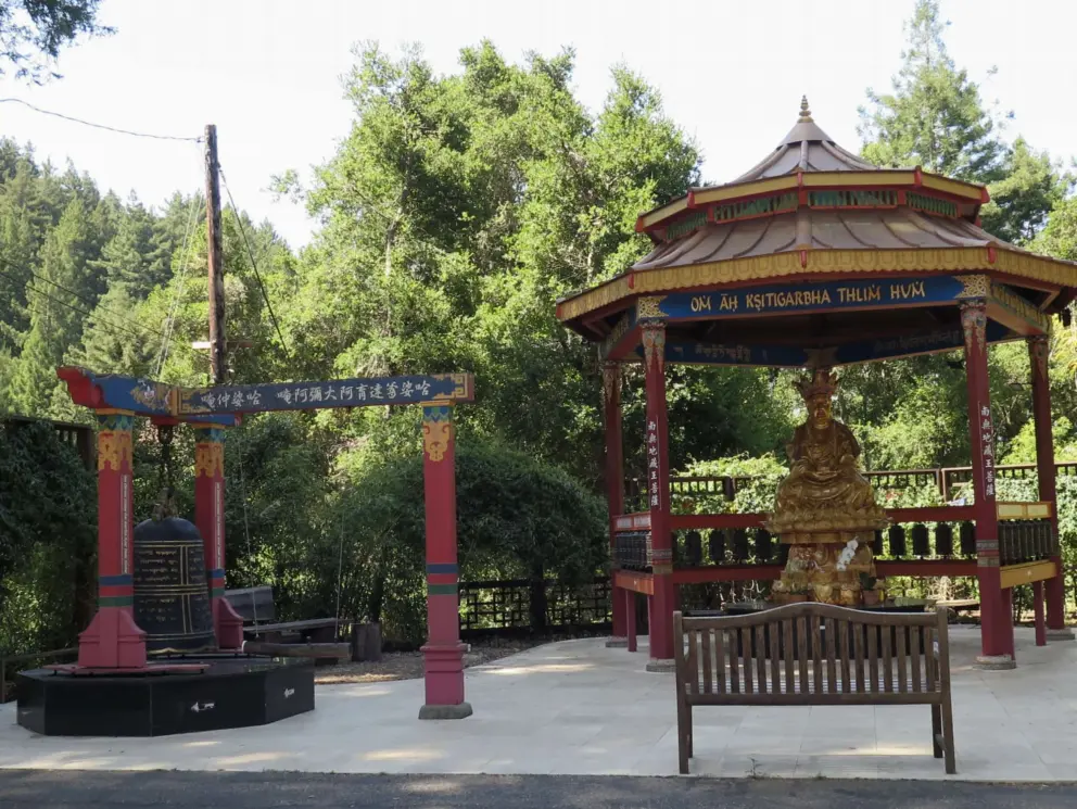 The second level has a bell and a golden Buddha statue. 