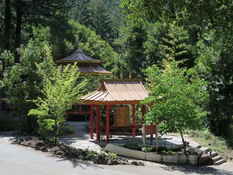 The second level, with prayer wheel with gold roof, and golden Buddha statue.