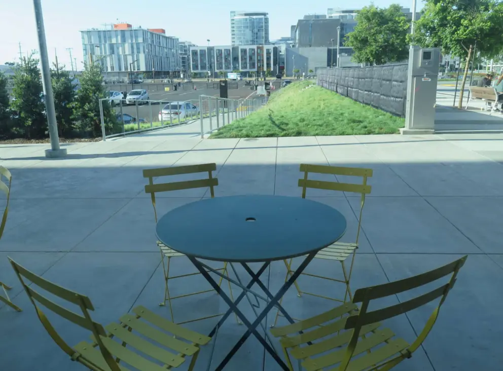 Seating looking out on contemporary landscaping at Arsicault Bakery.