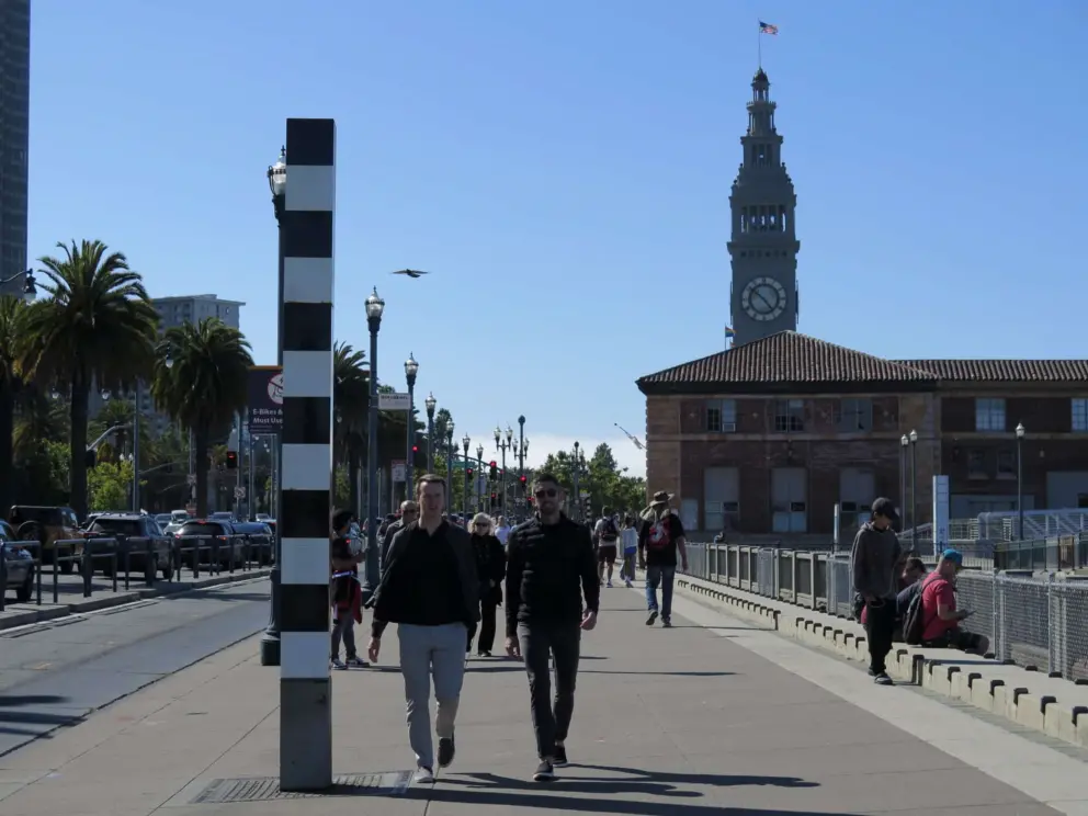 Walking along Embarcadero, with the Ferry Building nearby. 