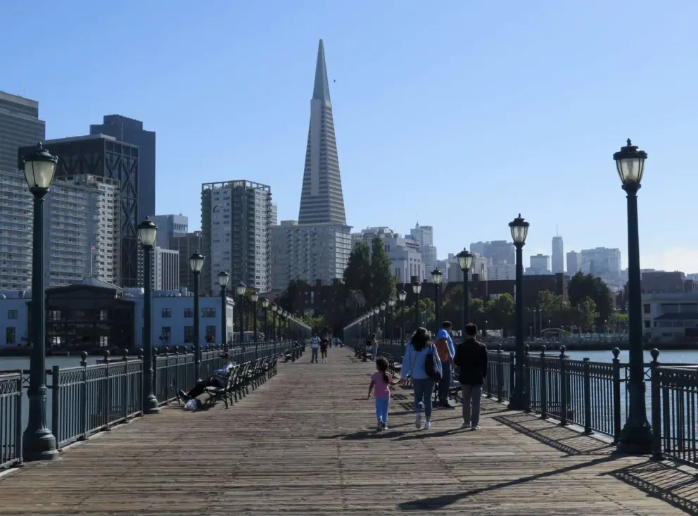 A family walks along Pier 7. 