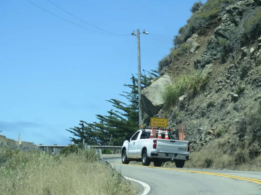 A pilot car leads us through an area where a rock is about to fall. 