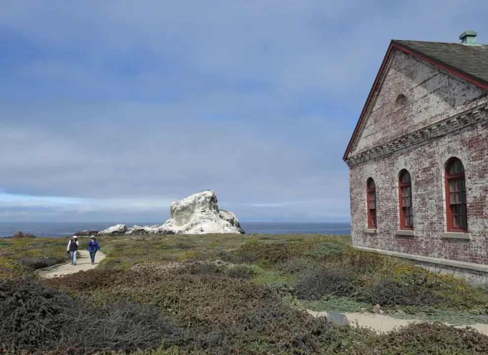 Oil signal building, white rocks, and ladies walking the path. 