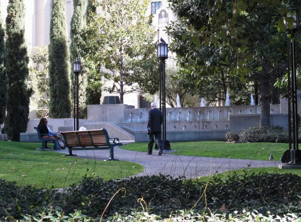 A businessman makes his way through Maguire Gardens, next door to the Central Library.